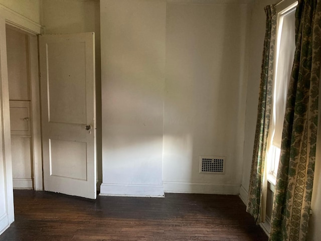 empty room featuring dark wood-type flooring