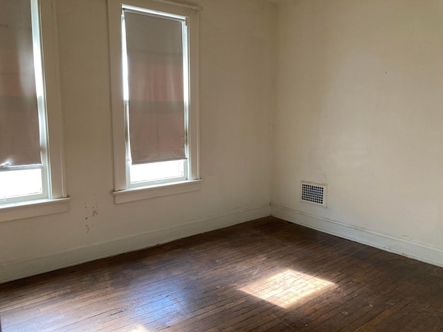 unfurnished room featuring dark hardwood / wood-style floors