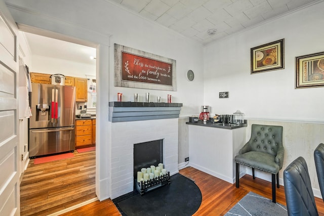 interior space featuring hardwood / wood-style floors and crown molding