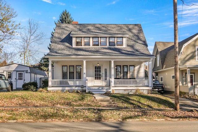 bungalow-style home featuring a porch and a front lawn