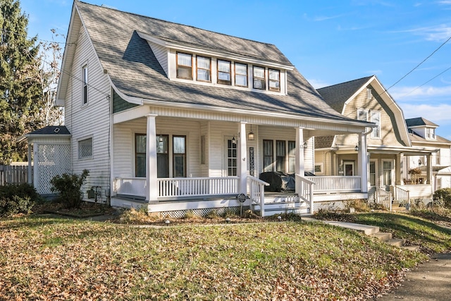 view of front facade with a front yard and a porch