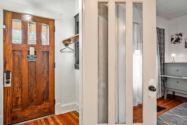 interior space featuring crown molding and hardwood / wood-style flooring