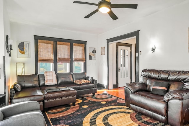 living room featuring ceiling fan and hardwood / wood-style flooring