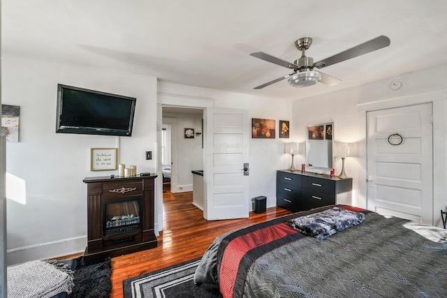 bedroom with ceiling fan and dark hardwood / wood-style floors