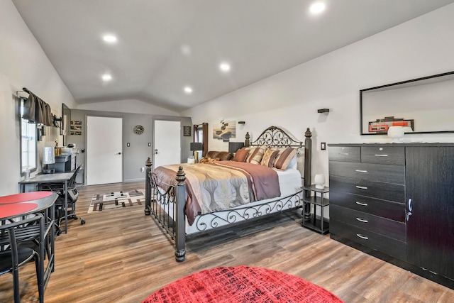 bedroom with hardwood / wood-style floors and vaulted ceiling