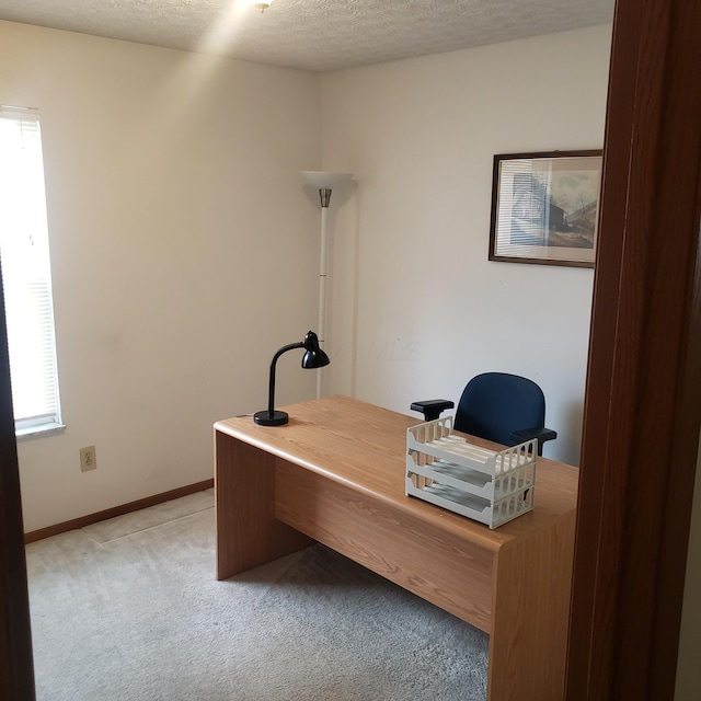 office with carpet and a textured ceiling