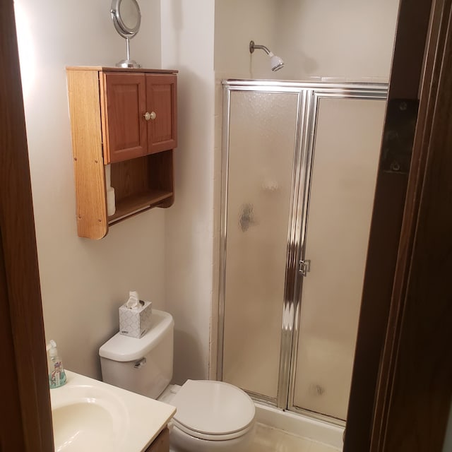 bathroom featuring toilet and walk in shower