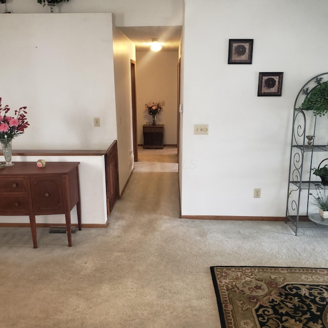 hallway with light colored carpet