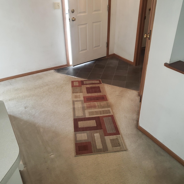 entryway with dark tile patterned flooring