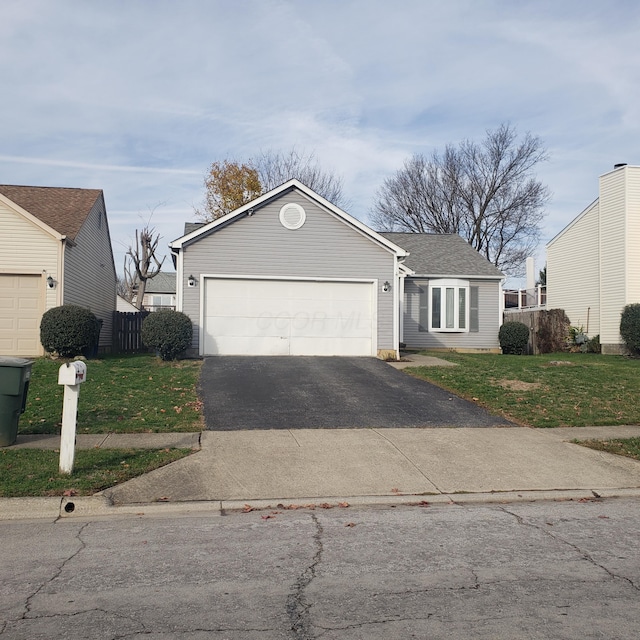 view of front of house featuring a front yard and a garage