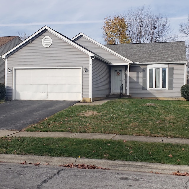 single story home featuring a front yard and a garage