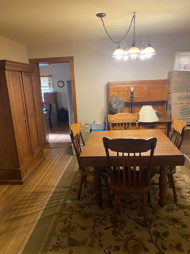 dining room featuring a chandelier and wood-type flooring