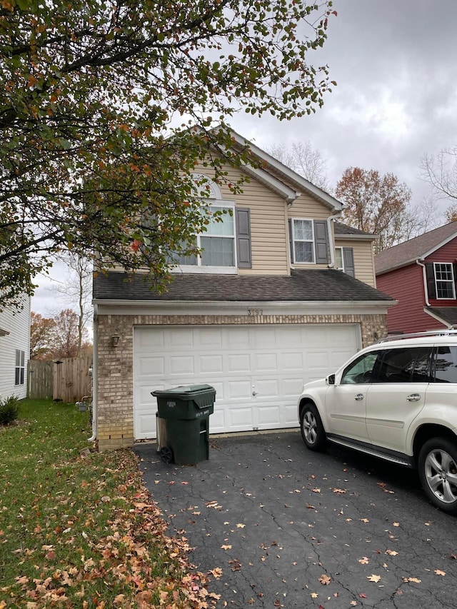 3197 Hogan Way, Columbus, OH 43219 - view of front facade with driveway, a garage, and brick siding