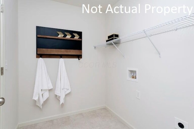 clothes washing area featuring baseboards, hookup for an electric dryer, washer hookup, and laundry area