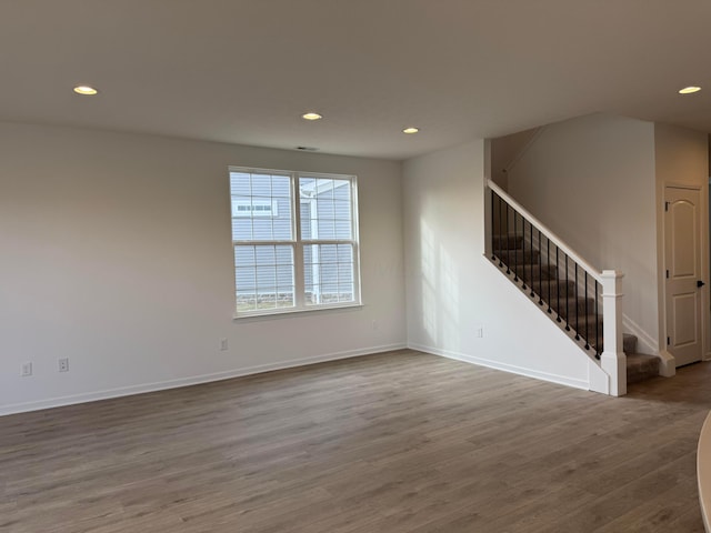 unfurnished room with wood-type flooring