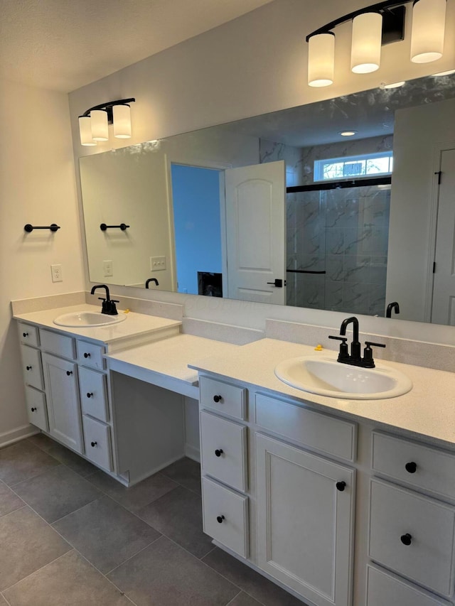 bathroom with vanity, an enclosed shower, and tile patterned flooring