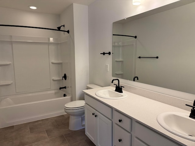 bathroom with double vanity, toilet, bathing tub / shower combination, and a sink