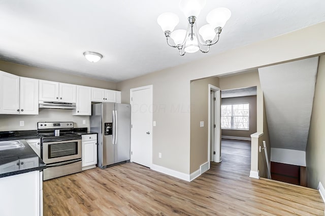 kitchen with appliances with stainless steel finishes, sink, white cabinets, light hardwood / wood-style floors, and an inviting chandelier