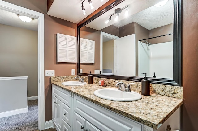 bathroom featuring vanity and a textured ceiling