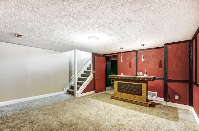 basement with carpet floors and a textured ceiling