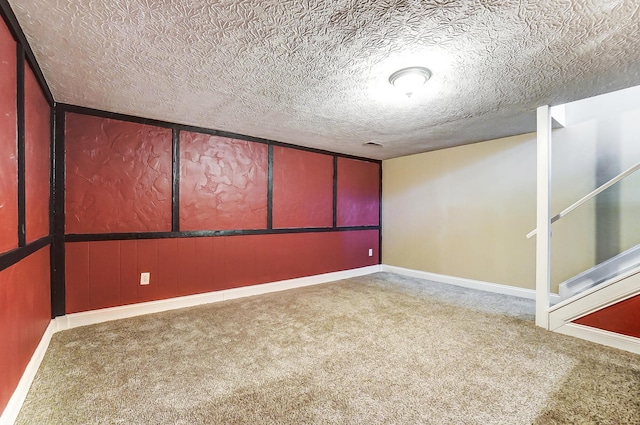 carpeted empty room featuring a textured ceiling