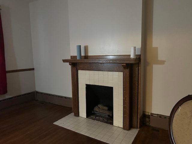 unfurnished living room featuring a tile fireplace and light wood-type flooring