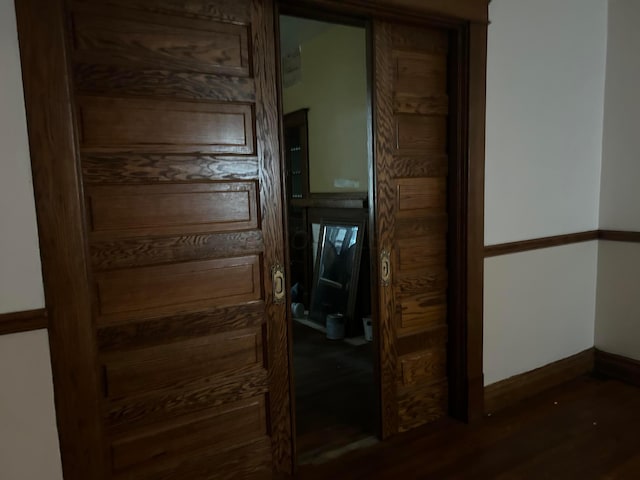 hall featuring dark wood-type flooring