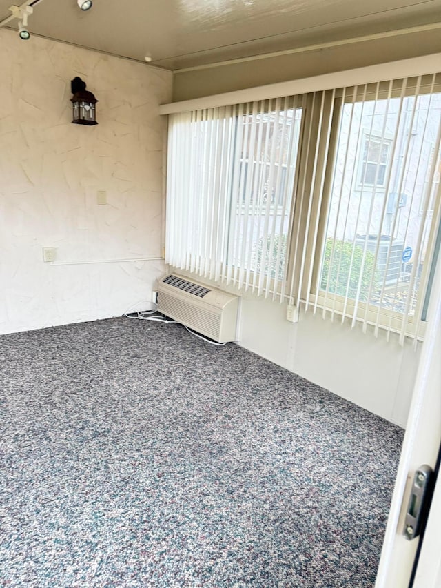 empty room featuring an AC wall unit