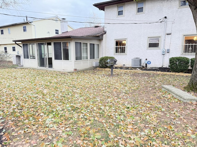 back of house featuring central AC and a sunroom