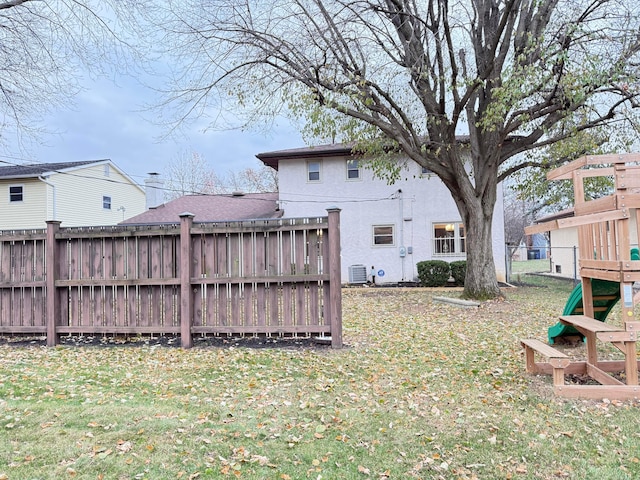 view of yard with a playground and central air condition unit