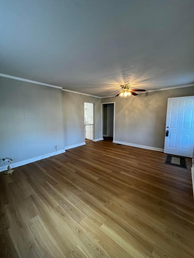 spare room with ceiling fan, crown molding, and hardwood / wood-style flooring