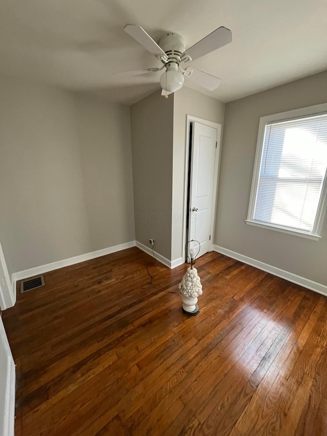 unfurnished bedroom with dark hardwood / wood-style flooring and ceiling fan