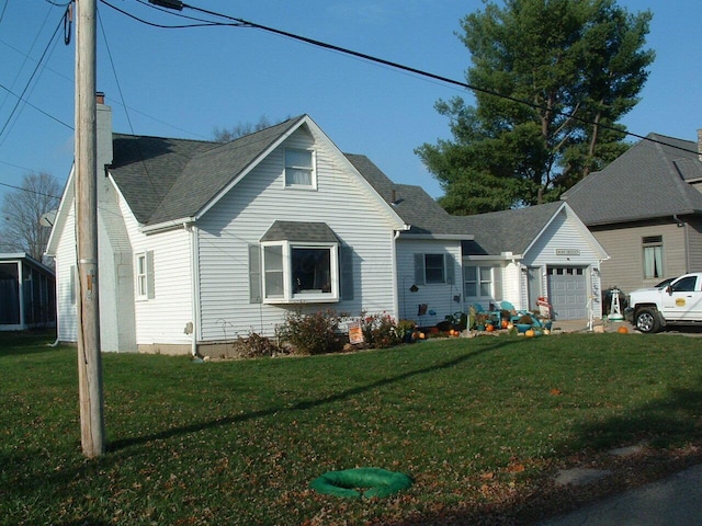 view of front facade with a front yard and a garage