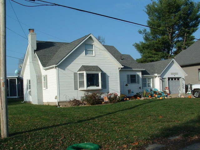 view of front of property featuring a garage and a front yard