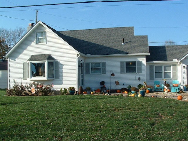 rear view of property with a lawn