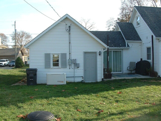 rear view of property featuring a lawn