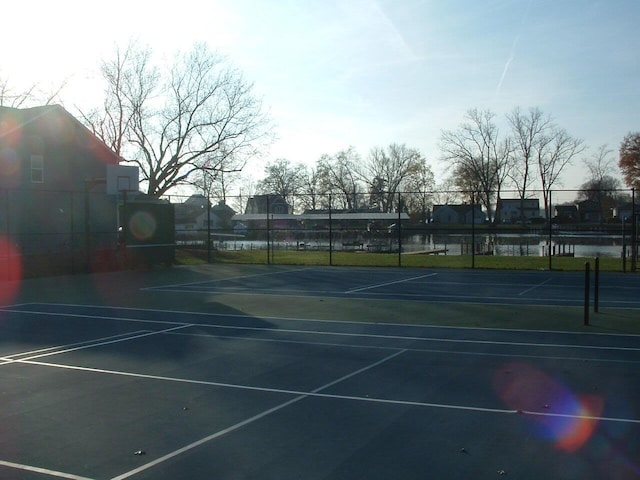 view of sport court featuring a water view