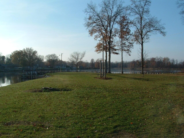 view of yard with a rural view and a water view