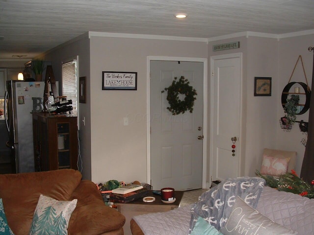 bedroom with stainless steel refrigerator and ornamental molding