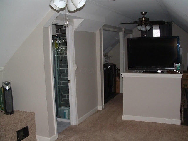 interior space featuring ceiling fan and vaulted ceiling