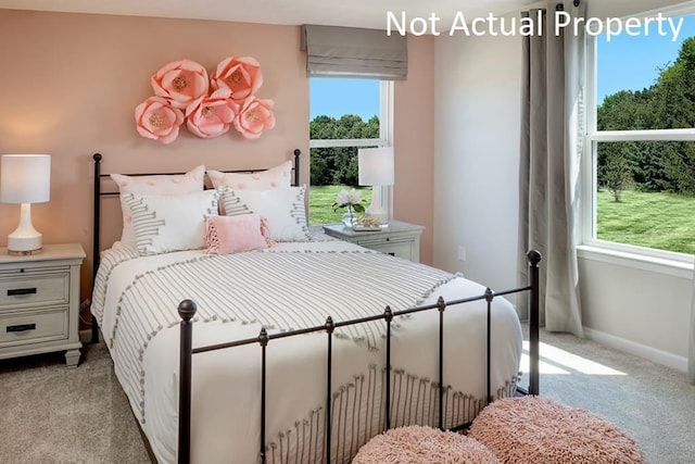 bedroom featuring baseboards and light colored carpet