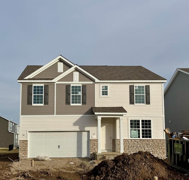 view of front of property with a garage, stone siding, and a shingled roof