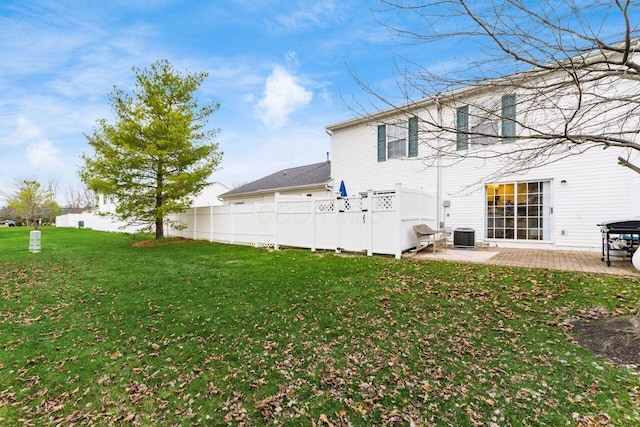 back of house with a yard, central AC unit, and a patio area