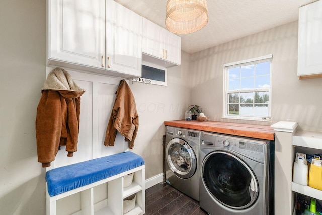 clothes washing area featuring dark hardwood / wood-style flooring, cabinets, a textured ceiling, and independent washer and dryer