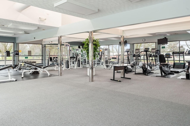 gym featuring carpet flooring and a textured ceiling