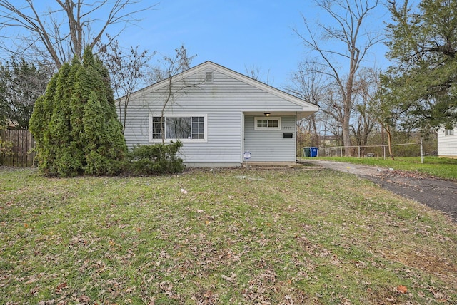 view of side of home with a yard