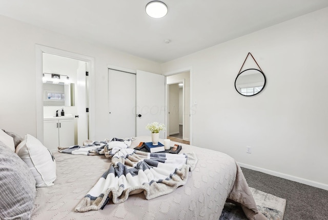 bedroom featuring ensuite bathroom and carpet floors