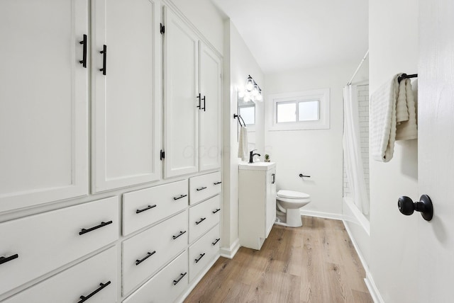 full bathroom with wood-type flooring, vanity, toilet, and shower / bath combo with shower curtain