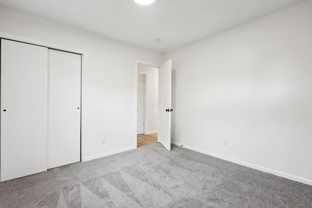 unfurnished bedroom with a closet and carpet