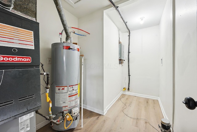 utility room with gas water heater and heating unit